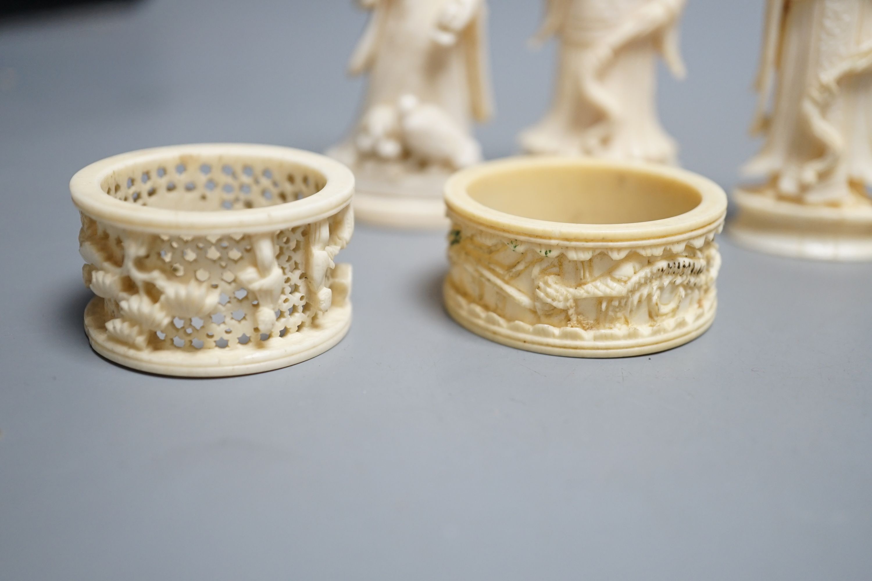 A Chinese ivory figure of Guanyin, a pair of ivory chess pieces, two Cantonese napkin rings and a Cantonese ivory plaque with flowers, 19th/early 20th century , tallest chess piece 8.5 cms high.